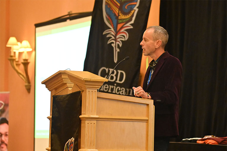 guest speaker on stage at the 2022 CBD American Shaman Franchise Conference